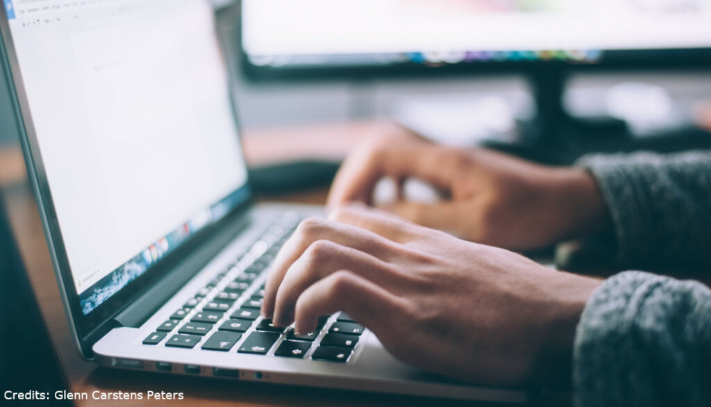 Image of person typing on laptop